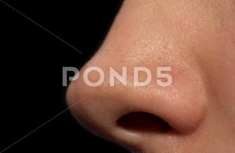 Women's nose on a black background. macro Stock Photos