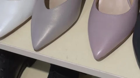 Women's pointed-toe shoes in a row on a shoe store shelf, close-up Stock Footage 331736592