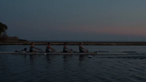 Women's quad rowing team training on lake Stock Footage 88838315
