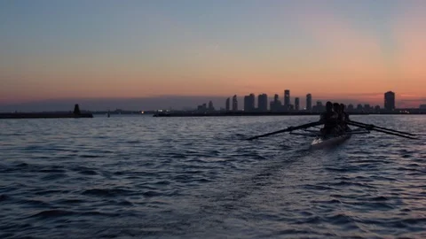 Women's quad rowing team training on lake Stock Footage 88838926