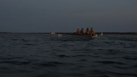 Women's quad rowing team training on lake Stock Footage 88839052