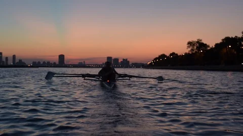 Women's quad rowing team training on lake Stock Footage 88839334