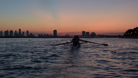 Women's quad rowing team training on lake Stock Footage 88839490