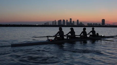 Women's quad rowing team training on lake Stock Footage 88839653