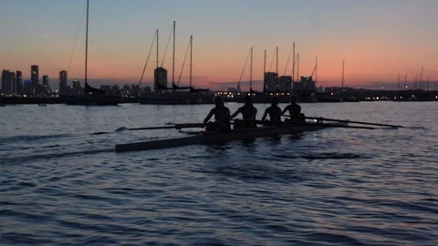 Women's quad rowing team training on lake Stock Footage 88841304
