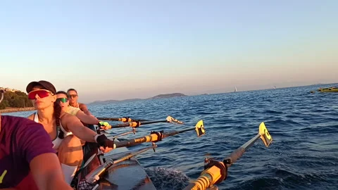 Women's rowing team paddling in sync on the open water Stock Footage 329830876