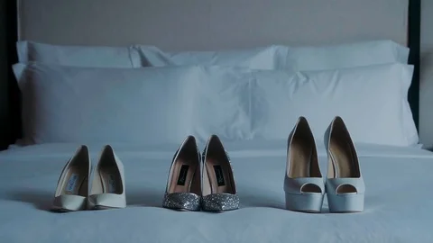Women's shoes on the bed. Stock Footage 129461628