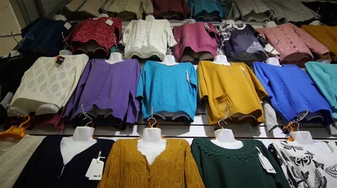 Women's Sweaters hanging in the Store Stock Footage 61987698