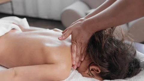 Womman lying on spa bed get back massage treatment scrub with spa salt and Stock Footage 160841809