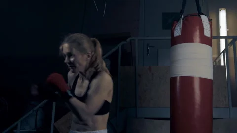 A womna fighter in arm wraps is practicing shadowboxing strikes  Stock Footage 273846400