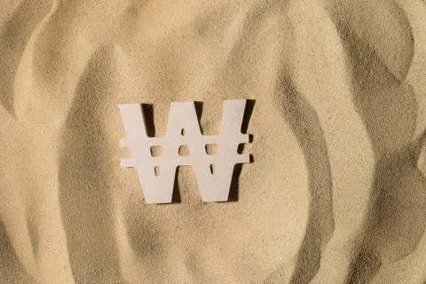 Won Sign On the Sand Stock Photos