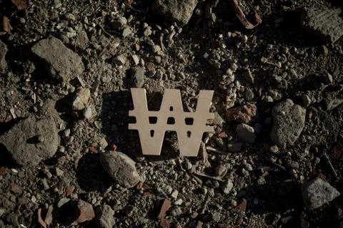 Won Symbol on Dirt Stock Photos