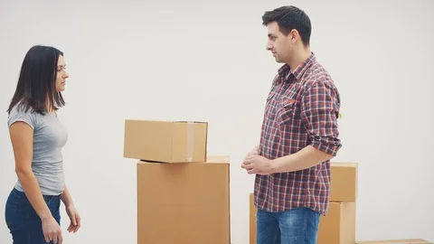 Wonam is shouting at the man, because he put the boxes in wrong place. She is Stock Footage 120176447