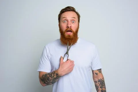 Wondered man with scissors is ready to cut the beard Stock Photos
