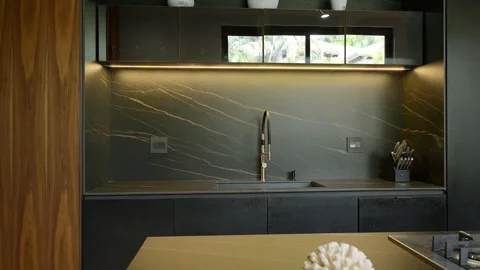 Wonderful black kitchen with mirror upper facades and marbled apron. Combination Stock Footage 257609961