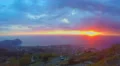 Wonderful ocean sunset, view on city from mountain peak, heavy clouds timelapse 4k or 4k+ Resolution
