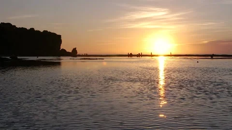 Wonderful orange sunset with silhouette of people on the horizon Stock Footage 143202653