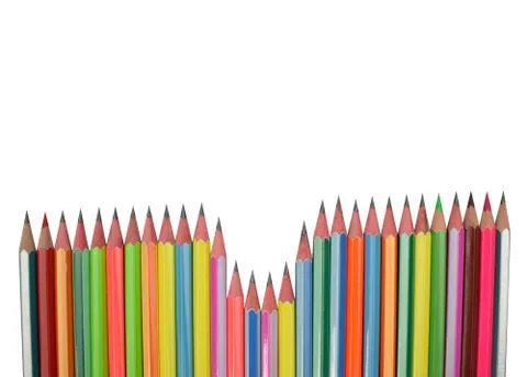 Wonderful pattern made with different colored wood pencil crayons on white ba Stock Photos
