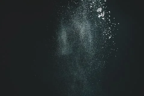 Wonderful pattern of white powder of light snow and flour explodes on black b Stock Photos