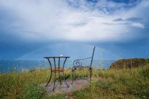 Wonderful seaside view with empty table and chair near the beach Stock Photos