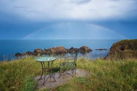 Wonderful seaside view with empty table and chair near the beach Stock Photos