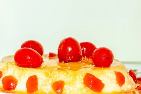 A wonderfully flavored pudding made with egg milk and sugar with red cherry.. Stock Photos