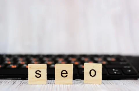 Wood block cube shape put the front computer keyboard with word SEO and empty Stock Photos