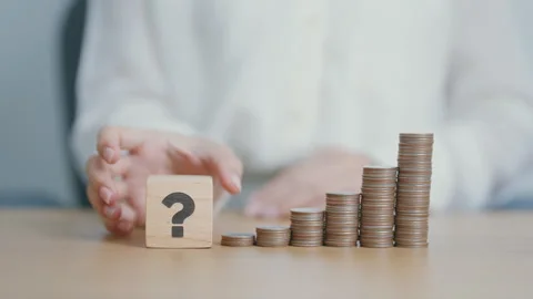 Wood block of Question mark, and coin stack .  Interest rate, GDP, stocks m.. Stock Footage 284702845