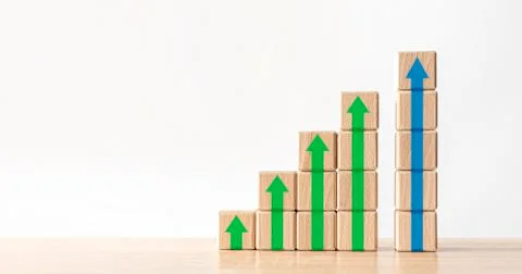 Wood block stacking as step stair with arrow up. Stock Photos