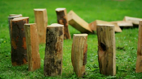 Wood bricks falling as chain reaction on green grass Stockbeeldmateriaal 27114514