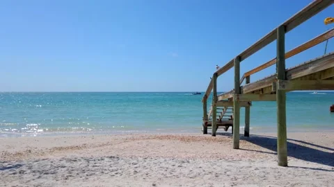 Wood Bridge Beach Access Bridge Blue Waves Boat and Birds in Background Stock Footage 236868720