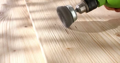 Wood brushing with wire cup brush for drill. Close up. Angle view. Stock Footage 243576658