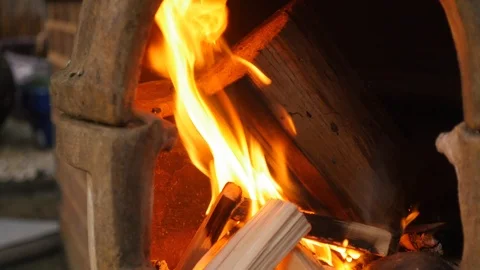 Wood burning in a chiminea Stockbeeldmateriaal 115058937