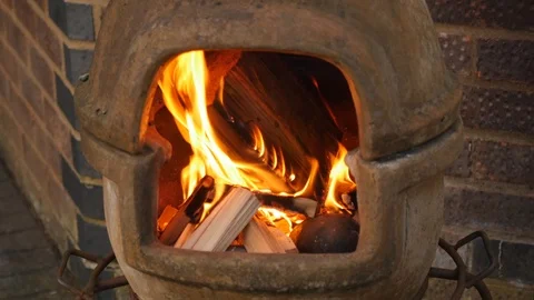 Wood burning in a chiminea Stockbeeldmateriaal 115058992