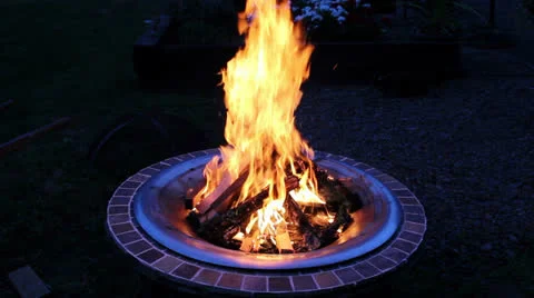Wood Burning Fire Pit with Orange Flames at Night 1080p Stock Footage 27085295