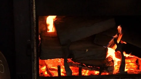Wood burning in a fireplace insert Stock Footage 93241310