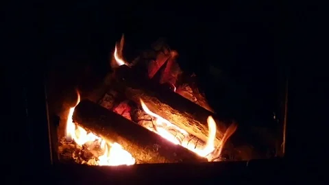 Wood burning inside a warm, red fireplace Stock Footage 72800997