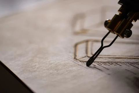 Wood burning tool creating pyrography pattern on wooden board Stock Photos