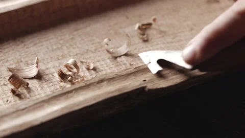 Wood carver processes the edges of an oak wood plank with a knife. artisan ma Stock Footage 166082221