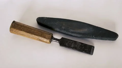 Wood chisel and whetstone isolated on white background Stock Footage 234126278