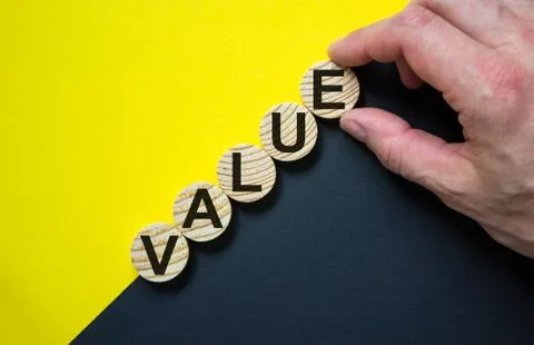 Wood circles with word 'value' stacking as step stair on paper yellow and bla Stock Photos