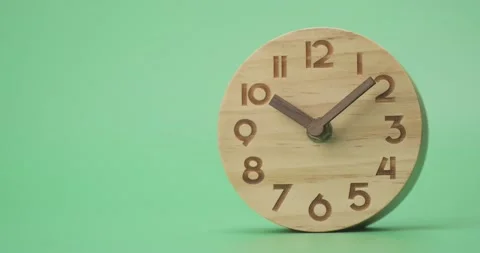 The wood clock is on green blackground. Stock Footage 163044450