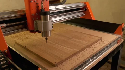 The wood cnc machine starts working and drills a circle into the Board blank Stock Footage 143377342