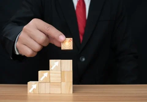 Wood cube block stacking with icon.Concept of business strategy and goal ac.. Stock Photos
