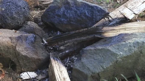A wood fire between three stones is dying out Video stock 150595332