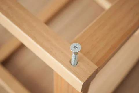 Wood frame assembly with visible screw detail during work Stock Photos