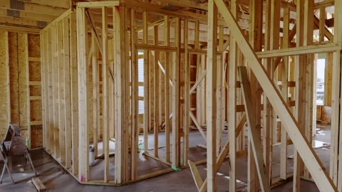 Wood framing inside a new residential house under construction with unfinished Stock Footage 335961865