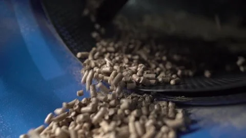 Wood fuel pellets fall on cells of delivering conveyor belt Stock-Footage 196017404