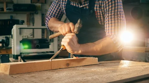 Wood is getting processed manually by a craftsman. Craftsman working in Video stock 113077603