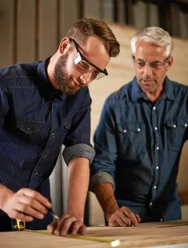 Wood, learning and carpentry apprentice with mentor in designer furniture Stock Photos